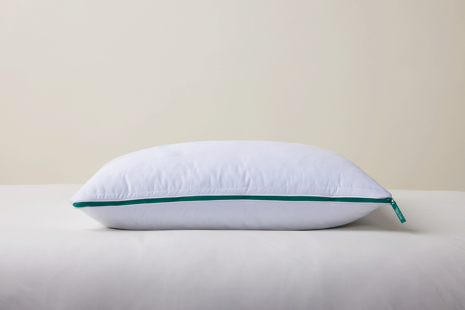 A white pillow that suddenly has the inner materials coming out of it.